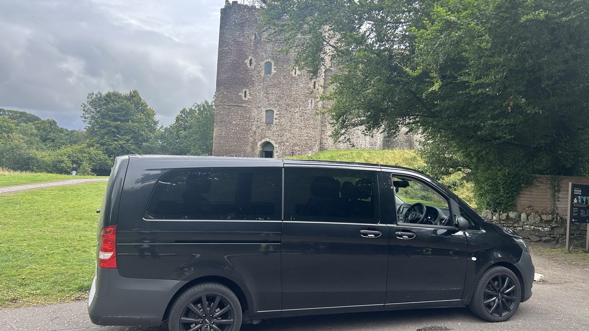 Black Mercedes Vito tour vehicle parked at Doune Castle